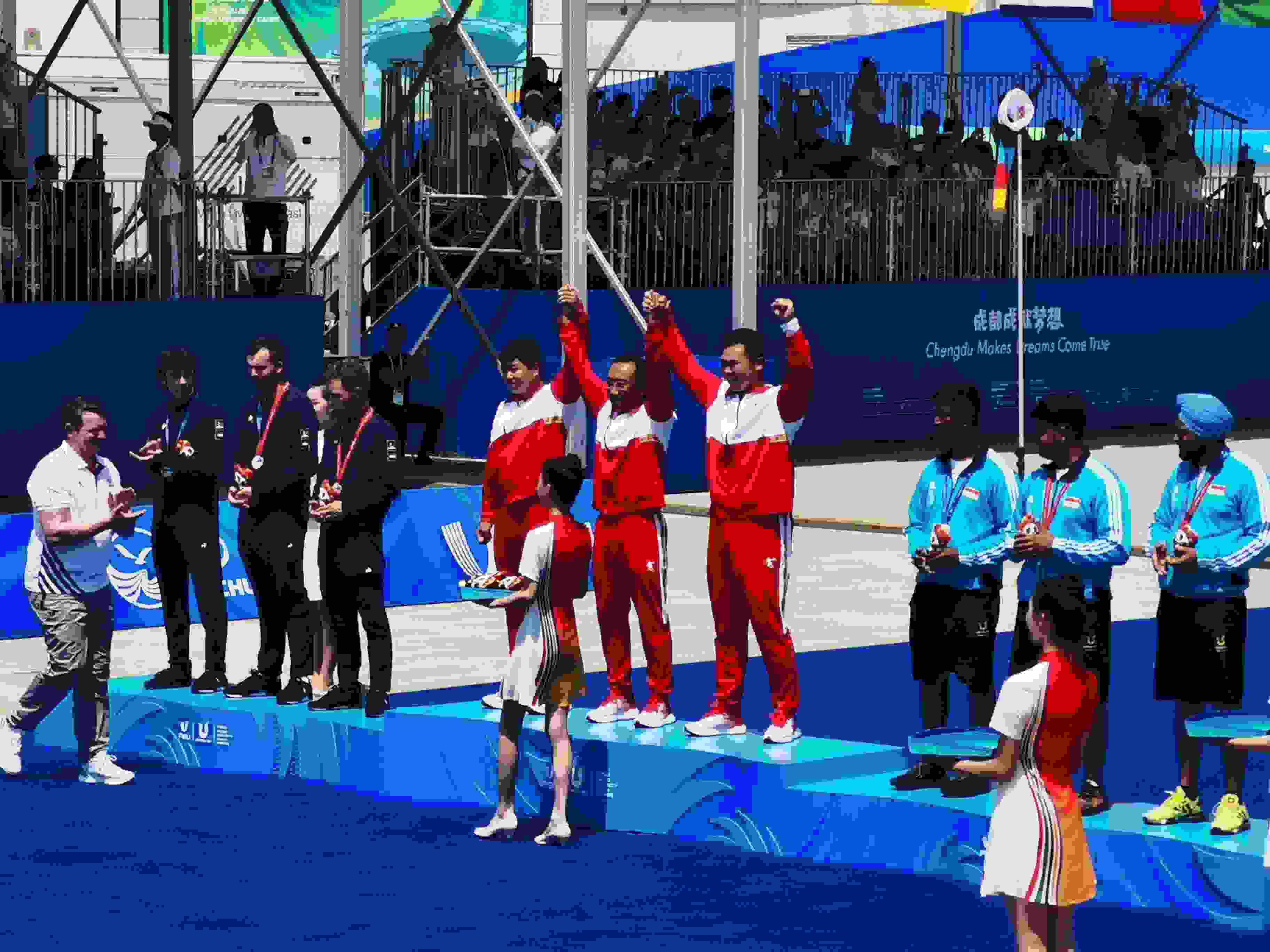 7月30日，在成都大運會男子復(fù)合弓團體頒獎儀式中，中國隊慶祝奪得冠軍。 人民網(wǎng)記者 楊磊攝