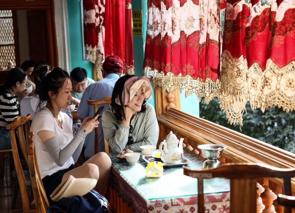 游客在新疆喀什古城景區(qū)百年老茶館內(nèi)品茶小憩（2023年9月7日攝）。新華社記者 蘭紅光 攝