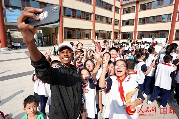 選手和學(xué)生們合影。人民網(wǎng) 盧鵬宇攝