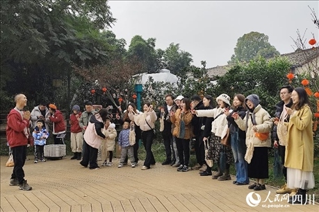 葉科（左一）給前來(lái)參與活動(dòng)的“柑爸柑媽”介紹生態(tài)種植果。人民網(wǎng)記者朱虹攝