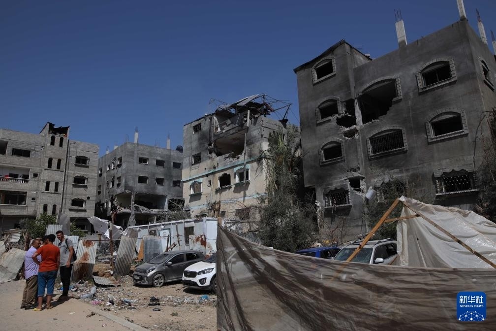這是6月8日在加沙地帶中部努賽賴特難民營拍攝的在以軍襲擊中受損嚴(yán)重的房屋及車輛。新華社發(fā)（馬爾萬·達(dá)烏德攝）